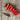 Red peppers and a pair of snips on a wooden surface