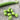 A collection of Robinson Peas on a wooden table with a closed pea pod in the background