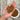 flat hand holding carlin peas over a wooden table
