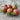 Six black cherry tomatoes grouped together on wooden table