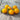 Six yellow cherry tomatoes grouped together on wooden table