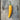 One large yellow Aji de Colorado Alpino chilli on a wooden table
