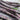 A close up of a bunch of purple and green Carters Polish Climbing French Beans on a wooden table