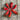 Red peppers arranged in a circular pattern on a wooden surface
