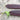 Close up of two purple mangetout pods on wooden table 